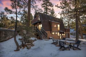 a log cabin in the woods in the snow at Larks Nest in Big Bear Lake in Big Bear Lake