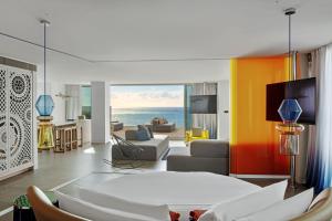 a living room with a couch and a table at W Ibiza in Santa Eularia des Riu +121 photos