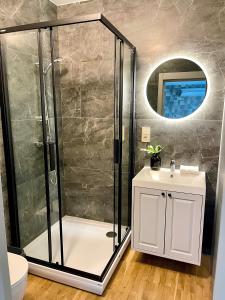 a bathroom with a shower and a sink at Saules apartment Klaipeda in Klaipėda +43 photos
