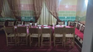 a dining room with a table and chairs and a table and chairsktop at Hostel amodou in Tinerhir