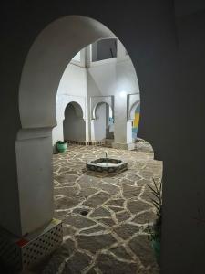 an archway in a building with a stone courtyard at Hostel amodou in Tinerhir