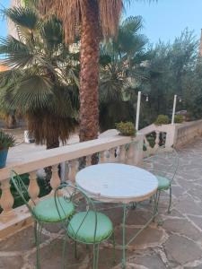a table and chairs sitting next to a fence at Hostel amodou in Tinerhir