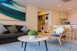 a living room with a couch and a table at 403 - Suva City Views Oceanfront Large Balcony in Suva