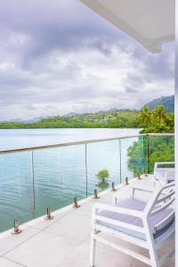 a balcony with two chairs and a view of the water at 403 - Suva City Views Oceanfront Large Balcony in Suva