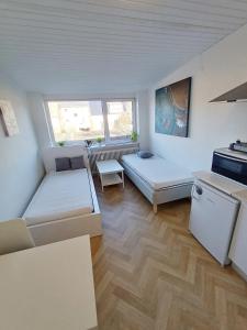 a living room with two beds and a couch at Double room 1 with Free Parking in Nørresundby