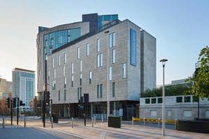 a building on a street in a city at Four Points Flex by Sheraton Cardiff in Cardiff