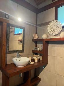 a bathroom with a sink and a mirror at Lodge Eden, SPA Privatif in Les Abymes