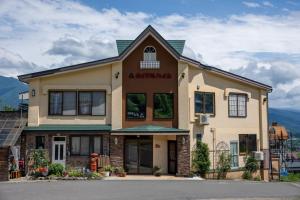a building with a sign on the front of it at メイプルハイム in Iiyama