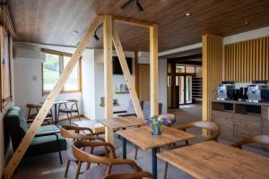 a dining room with wooden tables and chairs at メイプルハイム in Iiyama