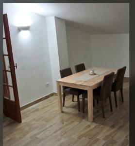 a wooden table and chairs in a room at Il piccolo artista b&b in Naso