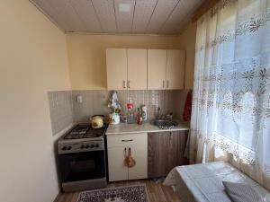 a small kitchen with a stove and a sink at Relax in mountains in İsmayıllı