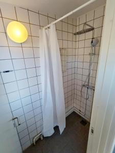 a bathroom with a shower with a white shower curtain at Double room 5 with Free Parking in Nørresundby