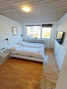 a bedroom with a bed and two windows at Double room 5 with Free Parking in Nørresundby