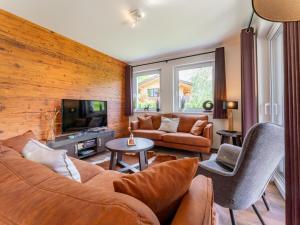 a living room with a couch and a tv at Werfenblick in Werfenweng