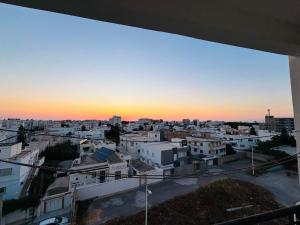 a view of a city at sunset at Le bienvenu in Sousse