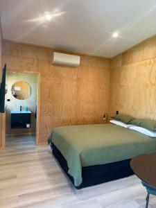 a bedroom with a large bed and a table at Pirongia Views Studio in Pirongia