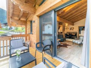 a screened in porch with a chair and a table at Chalet Sylvia in Krimml