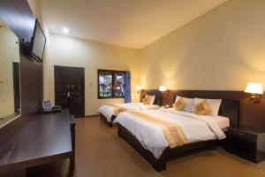 Postel nebo postele na pokoji v ubytování Bali Sandy Resort