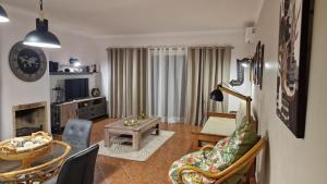 a living room with a couch and a table at Villa Do Mar in Porches