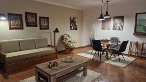 a living room with a couch and a table at Villa Do Mar in Porches