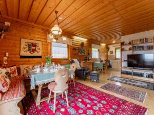 a living room with a dining table and a living room with at Landhaus zur Sonne in Diex