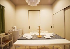 a dining room table with glasses and a cross on it at WAMARE Shibamata, Entire private two-story house, Traditional Tokyo Stay with Easy Access to Haneda & Narita Airports, up to 4pax in Tokyo