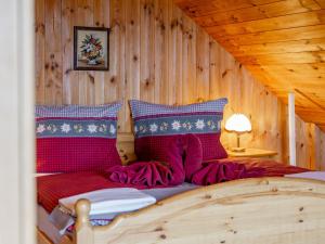 a bedroom with a bed in a wooden cabin at Landhaus zur Sonne in Diex