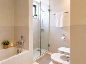 a bathroom with a shower and a toilet and a sink at Bom dia Parque Nações Lisboa W in Lisbon +17 photos