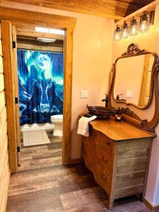 a bathroom with a horse picture on the wall at Riverfront, Authentic, Luxury Log Cabin-Gray Wolf in Wasilla +21 photos