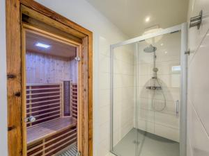 a bathroom with a shower and a glass door at See Chalet 50 in Lake Pressegg +51 photos