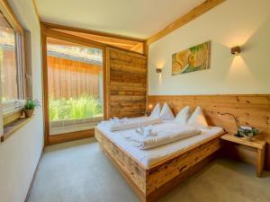 a bedroom with a bed and a window at See Chalet 50 in Lake Pressegg