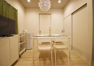 a kitchen with a table and chairs and a tv at WAMARE Shibamata, Entire private two-story house, Traditional Tokyo Stay with Easy Access to Haneda & Narita Airports, up to 4pax in Tokyo +11 photos