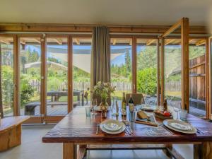 a dining room with a table and a large window at See Chalet 50 in Lake Pressegg