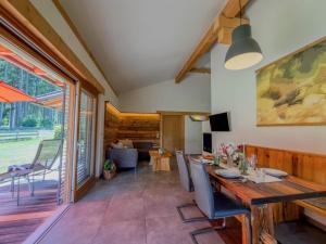 a living room with a wooden table and chairs at Oselitzen 56 in Lake Pressegg