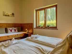 a bedroom with two beds and a window at Oselitzen 56 in Lake Pressegg