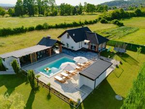 an aerial view of a house with a swimming pool at Odmaraliste Paradise14 - Private Villa with Heated Pool & Jacuzzi in Rainci Gornji