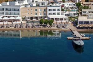 a boat is docked at a dock in the water at Patmos Aktis, a Luxury Collection Resort & Spa, Greece in Patmos