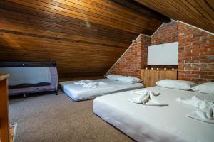 a room with three beds and a flat screen tv at Odmaraliste Paradise14 - Private Villa with Heated Pool & Jacuzzi in Rainci Gornji +51 photos