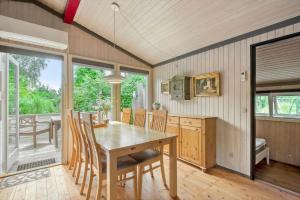 a kitchen and dining room with a table and chairs at 8159-Praesto-Vagtelvej-8 in Præstø