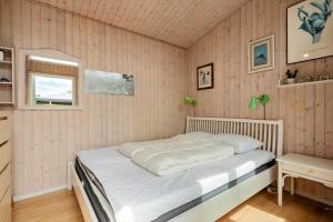 a bedroom with a white bed and a window at 8159-Praesto-Vagtelvej-8 in Præstø +17 photos