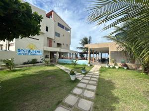 a view of a building with a swimming pool at Pousada e Restaurante Império do Marisco in Maragogi