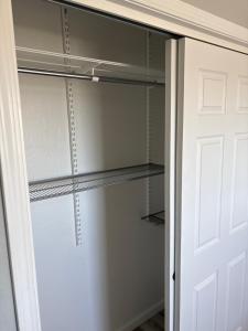 a walk in closet with a glass door at 907 elm in Rodeo