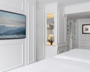 a room with a flat screen tv on a wall at Wedgewood Hotel & Spa - Relais & Chateaux in Vancouver