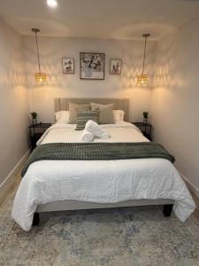 a bedroom with a large bed with two towels on it at The Ogieva Suites in Airdrie