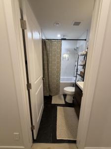 a bathroom with a shower and a toilet and a sink at The Ogieva Suites in Airdrie +44 photos