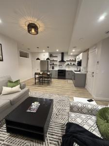 a living room with a couch and a table at The Ogieva Suites in Airdrie