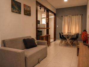 a living room with a couch and a table at Flat com Jacuzzi em Capitólio - Cantinho do Lago 1 in Capitólio