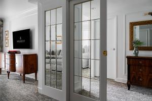 a room with a glass door and a bedroom at Wedgewood Hotel & Spa - Relais & Chateaux in Vancouver