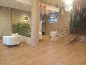 a lobby with stairs and a sign that reads seymex surgery at Paskary Hotel in Cajamarca