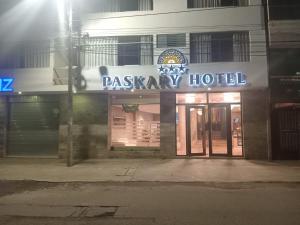 a building with a sign for a casino hotel at night at Paskary Hotel in Cajamarca